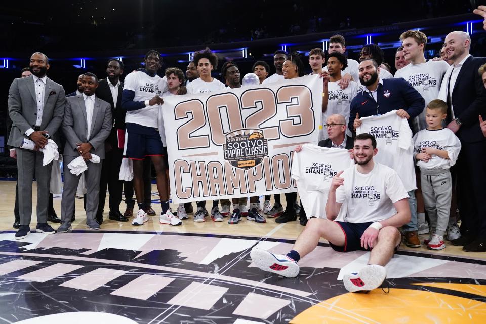 UConn poses for photos after an NCAA college basketball game against Texas in the final of the Empire Classic tournament Monday, Nov. 20, 2023, in New York. (AP Photo/Frank Franklin II)