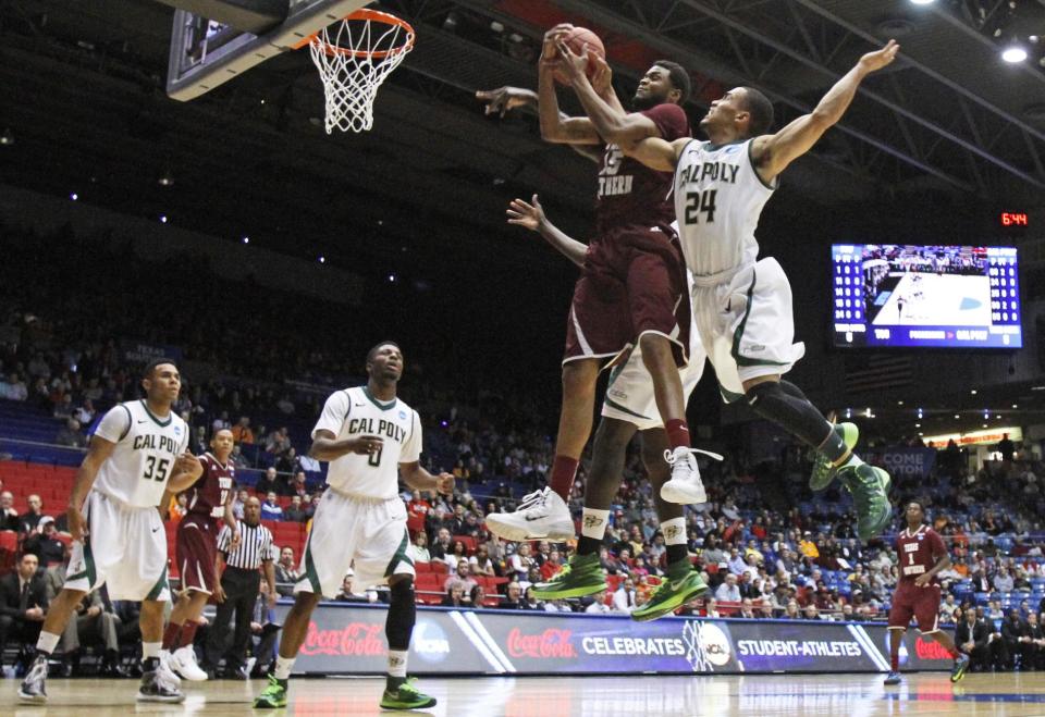 Texas Southern forward D'Angelo Scott (15) goes up for a rebound against Cal Poly guard Jamal Johnson (24) in the first half of a first-round game of the NCAA college basketball tournament on Wednesday, March 19, 2014, in Dayton, Ohio. (AP Photo/Skip Peterson)