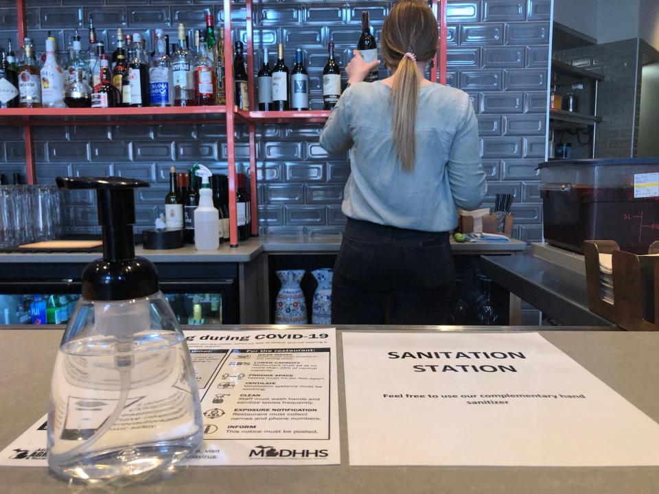 Kelli Combs with 1983 Restaurants cleans the bar area at Poquito on Wednesday, March 31, 2021, in Holland.