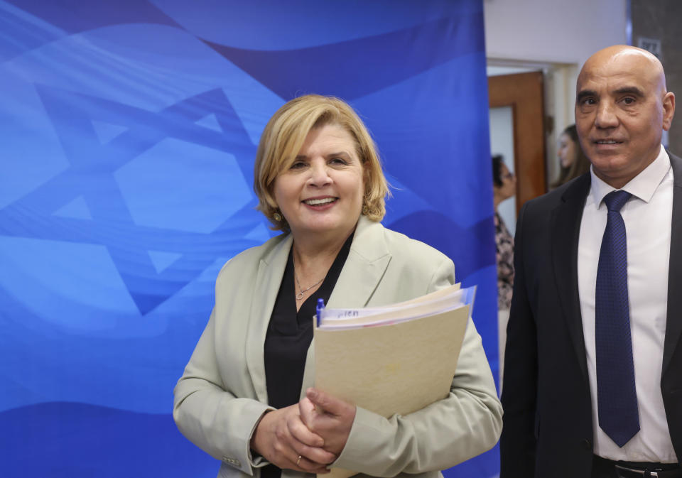 Israeli Minister of Economy Orna Barbivai, left, and Minister in the Finance Ministry Hamad Amar arrive to attend the first weekly cabinet meeting of the new government in Jerusalem, Sunday, June 20, 2021. Prime Minister Naftali Bennett opened his first Cabinet meeting on Sunday since swearing in his new coalition government with a condemnation of the newly elected Iranian president, whom he called “the hangman of Tehran.” (Emmanuel Dunand/Pool Photo via AP)