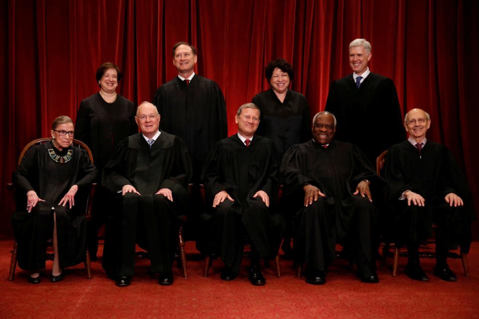 Roberts leads the Supreme Court in taking a new family photo including Gorsuch, their most recent addition, at the Supreme Court building in Washington