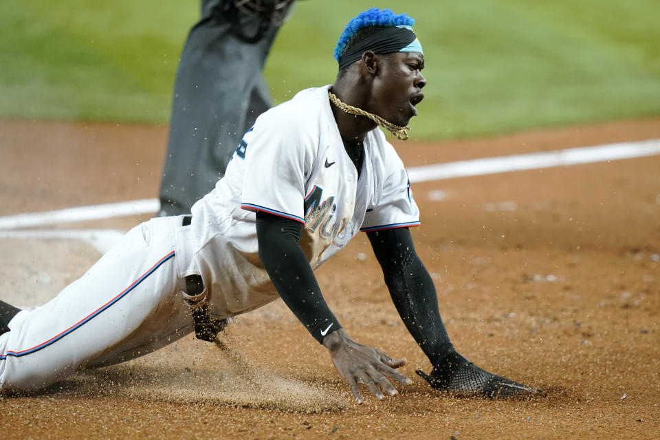 Miami Marlins' Jazz Chisholm Jr. scores on a sacrifice fly hit by Jesus Aguilar during the first inning of a baseball game against the Washington Nationals, Wednesday, May 18, 2022, in Miami. (AP Photo/Lynne Sladky)