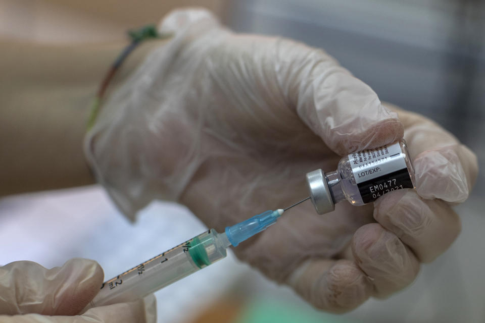 A nurse prepares the Pfizer-BioNTech COVID-19 vaccine for residents at DomusVi nursing home in Leganes, Spain, Wednesday, Jan. 13, 2021. Spain's rate of infection has shot up to 435 cases per 100,000 residents in the past two weeks, prompting new restrictions as authorities try to bring vaccination up to speed. (AP Photo/Manu Fernandez)