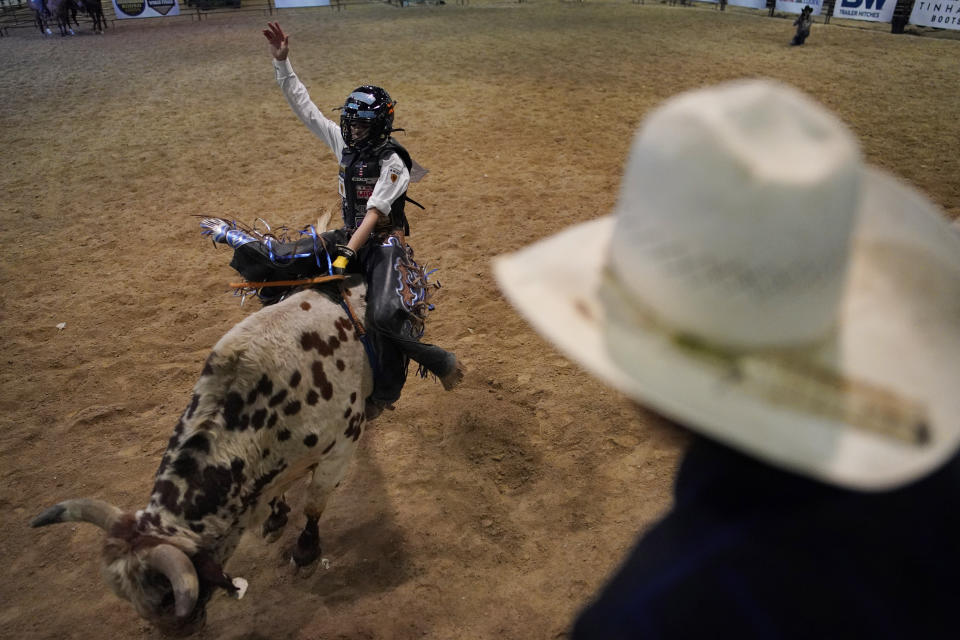 Najiah Knight competes during the Junior World Finals rodeo, Thursday, Dec. 7, 2023, in Las Vegas. Najiah, a high school junior from small-town Oregon, is on a yearslong quest to become the first woman to compete at the top level of the Professional Bull Riders tour. (AP Photo/John Locher)