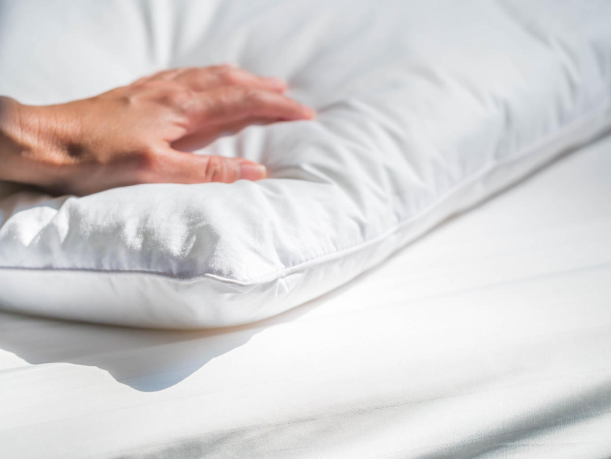 Add a dust mite cover to pillows and mattress to reduce allergies. (Photo: Getty)