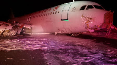 An Air Canada Airbus A320 lies in the snow after it skidded off the runway at Halifax International Airport, Nova Scotia March 29, 2015, in this handout courtesy of the Transportation Safety Board of Canada. The Air Canada Flight 624 crash-landed in the east coast city of Halifax and went off the runway early on Sunday, local media reported, with the airline confirming 23 passengers and crew suffered non-life threatening injuries. REUTERS/Transportation Safety Board of Canada/Handout via Reuters