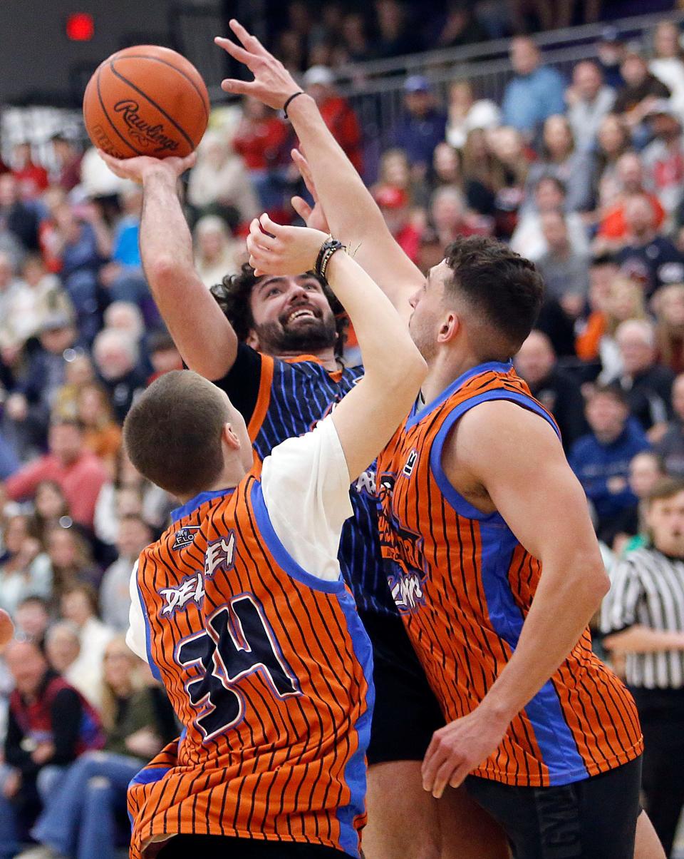 South Alumni All-Stars' Isaiah Alsip (2) puts up a shot against Alumni North All-Stars' Ethan DeLaney (34) and Max Waldruff (20) during the News Journal All-Star Classic Friday, March 29, 2024 at Lexington High School.