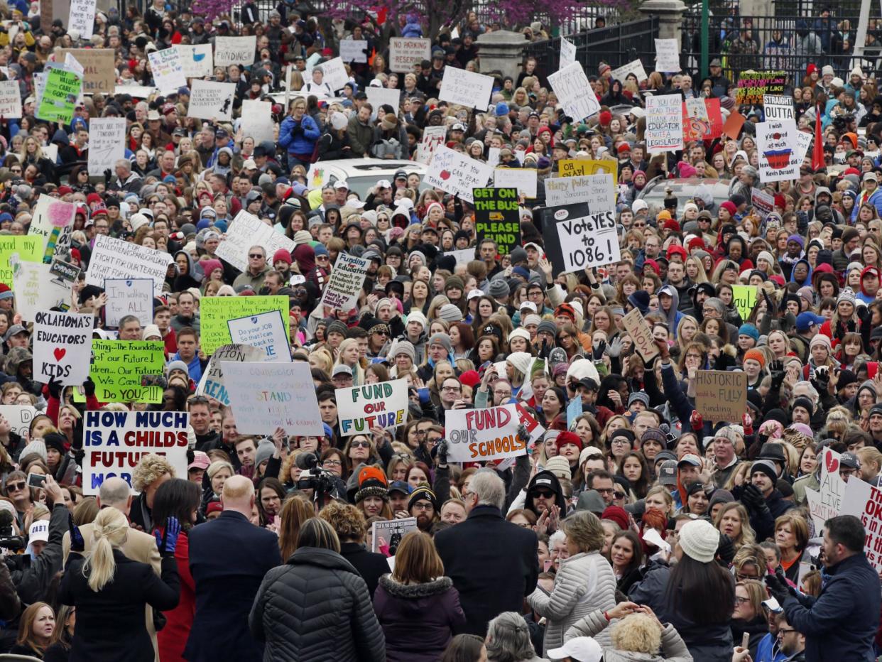 The crowd cheers during a teacher rally at the state Capitol in Oklahoma City on 2 April 2018. Teachers were holding separate protests in Oklahoma and Kentucky on Monday to voice dissatisfaction with issues like pay and pensions: AP Photo/Sue Ogrocki