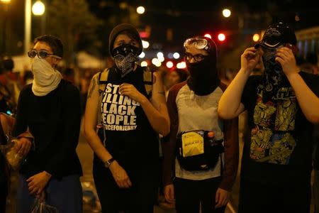 Demonstrators make a line across the road after curfew while protesting the police shooting of Keith Scott in Charlotte, North Carolina, U.S., September 25, 2016. REUTERS/Mike Blake