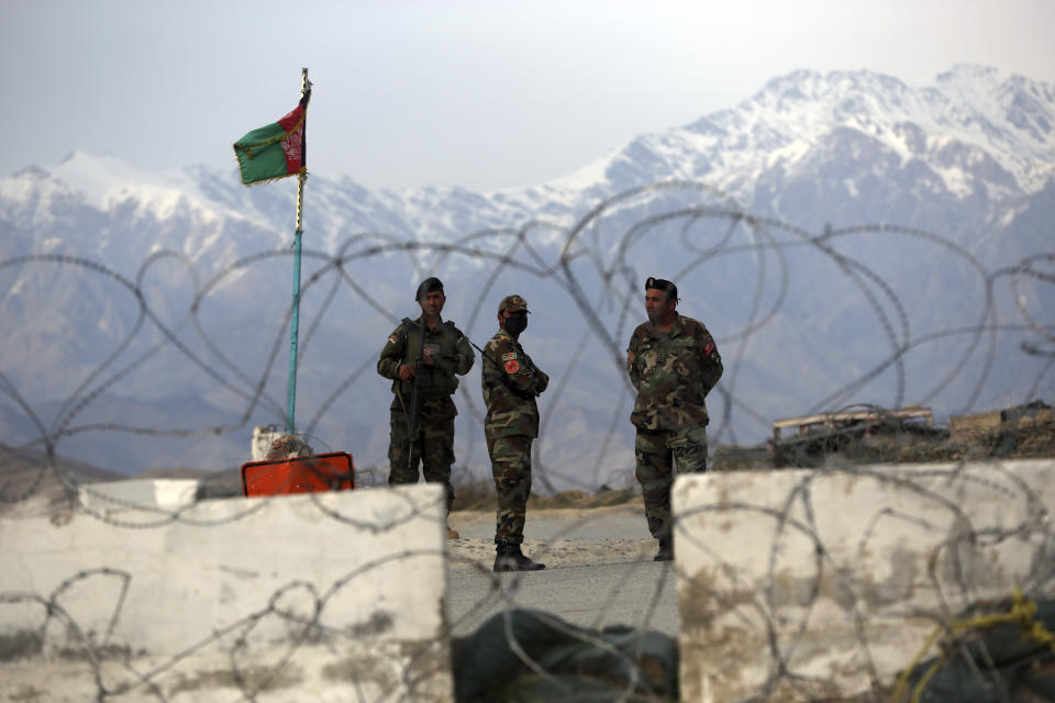 Afghan National Army soldiers stand guard at a checkpoint near the Bagram base in northern Kabul, Afghanistan, Wednesday, April 8, 2020. An Afghan official said Wednesday that the country has released 100 Taliban prisoners from Bagram, claiming they are part of 5,000 detainees who are to be freed under a deal between insurgents and U.S. But the Taliban says they have yet to verify those released were on the list they had handed over to Washington during negotiations. (AP Photo/Rahmat Gul)