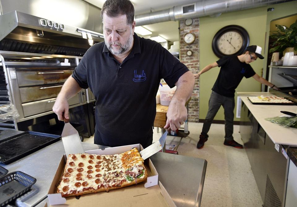 Virgil's Plate Co-owner Gary Fleming boxes up a pizza in this 2016 file photo.