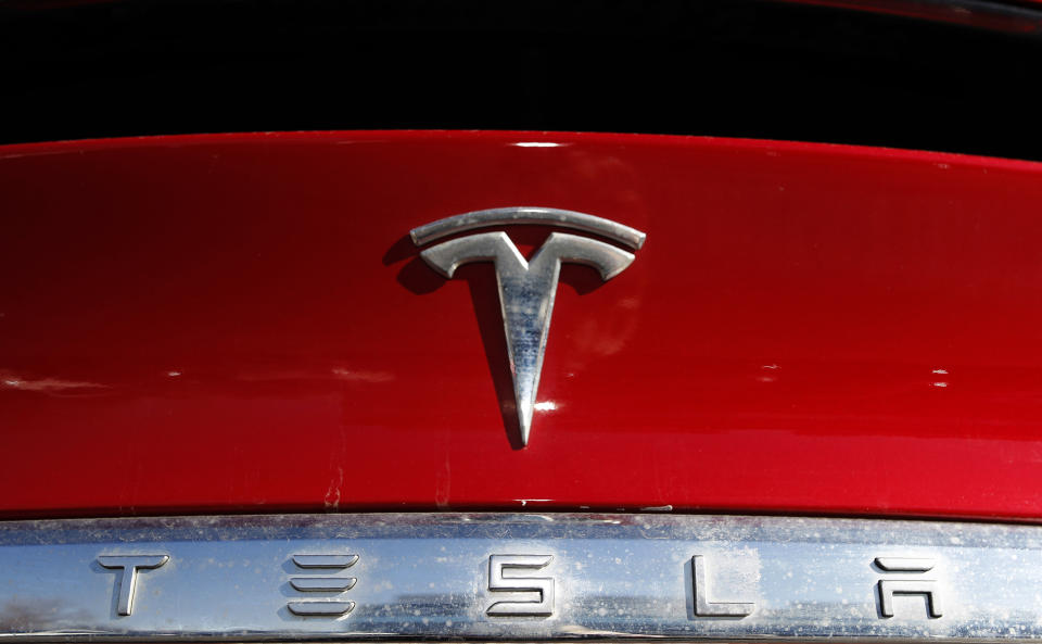 FILE - The Tesla company logo sits on an unsold 2020 Model X at a Tesla dealership in Littleton, Colo., Feb. 2, 2020. A Tesla that crashed into a firetruck in California in February 2023 was operating on one of the company's automated driving systems, U.S. safety regulators said Wednesday, March 8. (AP Photo/David Zalubowski, File)