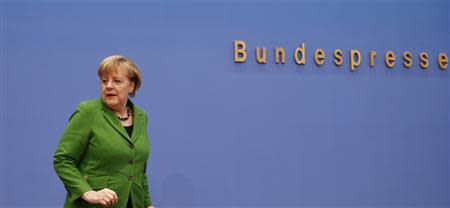 German Chancellor Angela Merkel, leader of the Christian Democratic Union (CDU) attends a news conference after signing a preliminary agreement with Horst Seehofer of the Christian Social Union (CSU) and Sigmar Gabriel of the Social Democratic Party (SPD), in the Bundespressekonferenz in Berlin, November 27, 2013. REUTERS/Thomas Peter