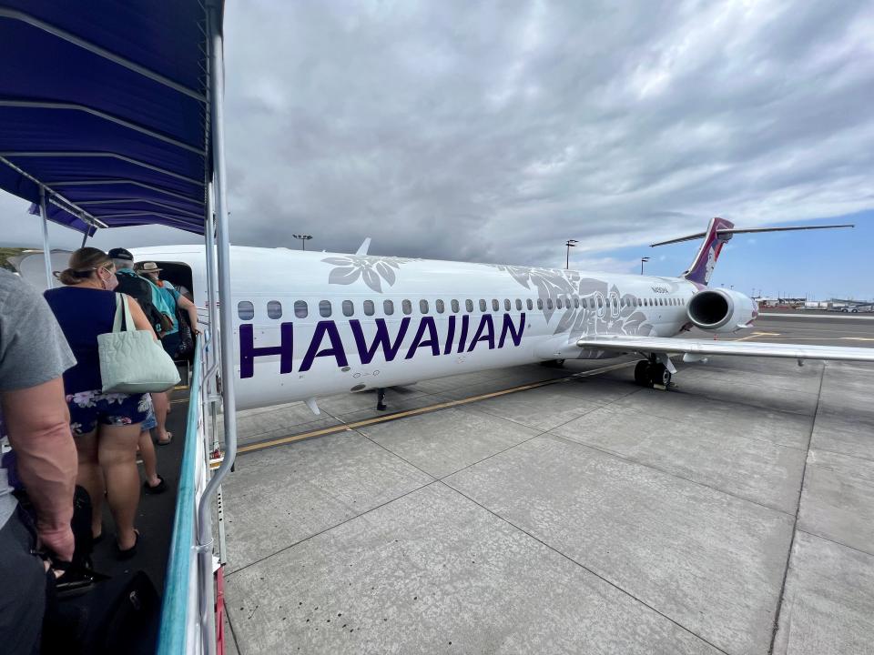 exterior of a hawaiian airliens plane on the loading dock