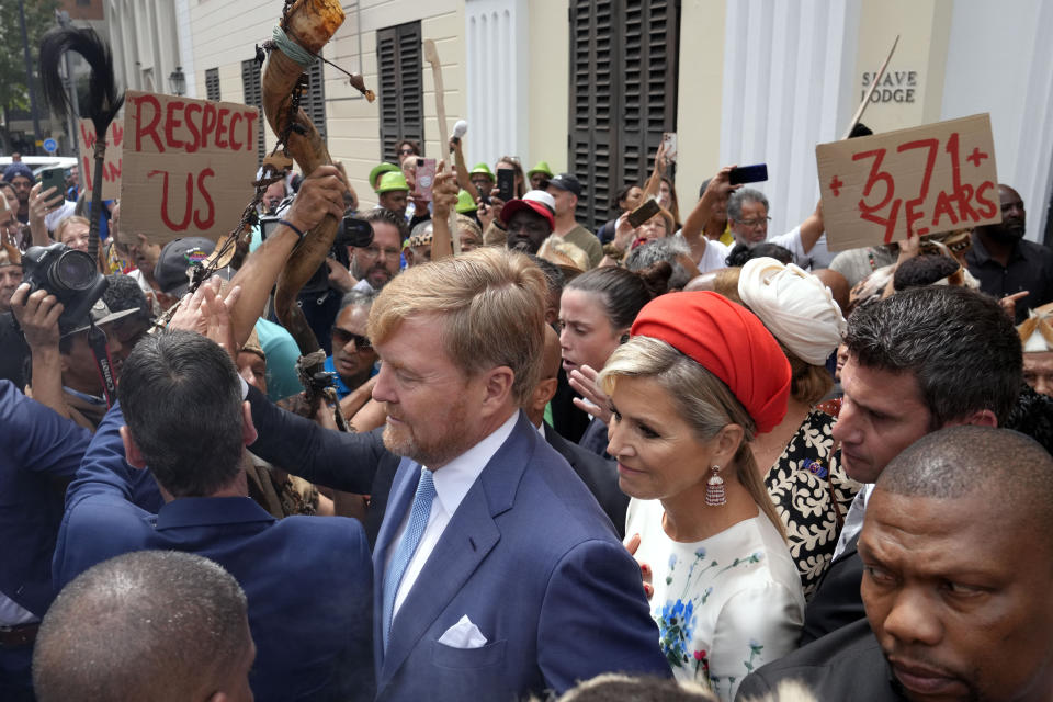 Khoisan protesters surround King Willem Alexander and Queen Maxima of the Netherlands at the Iziko Slave Lodge museum in Cape Town during their state visit to South Africa Friday, Oct. 20, 2023. The king and queen of the Netherlands were confronted by angry protesters in South Africa on a visit Friday to a monument that traces part of their country's involvement in slavery as a colonial power 300 years ago. (AP Photo/Nardus Engelbrecht)