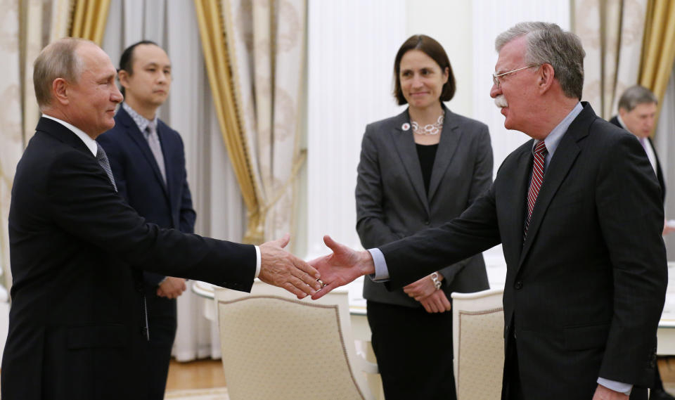 Russian President Vladimir Putin, left, shakes hands with U.S. national security adviser John Bolton during their meeting in the Kremlin on Tuesday. (Photo: Alexander Zemlianichenko/AP)