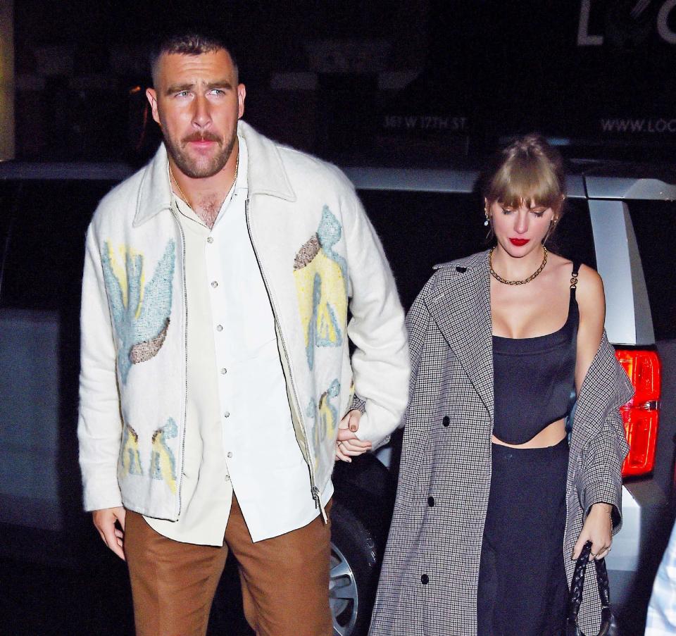 Closeup of Travis and Taylor holding hands during a night out