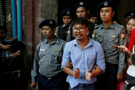 Detained Reuters journalist Wa Lone speaks to the media, while escorted by police, after a court hearing in Yangon, Myanmar May 22, 2018. REUTERS/Ann Wang