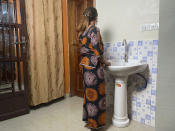 Anifa stands in her home in the eastern Congo town of Goma on Friday, March 5, 2021. In 2019, World Health Organization Dr. Boubacar Diallo, of Canada, met her when she was working in an Ebola treatment center in Beni, eastern Congo. She said Diallo told her: “How can a beautiful girl like you work here, testing people’s temperatures and washing their hands? That’s terrible.” She said he offered her another job at five times more than her current salary where “the conditions were very simple,” according to him. She rejected Diallo’s offer, saying that “if he hires me after sleeping with him...I would be a sex slave, not a WHO employee.” Diallo rejected those claims outright. (AP Photo/Kudra Maliro)