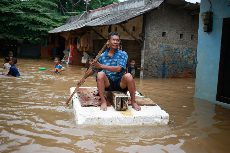 <p>An Indonesian man sits on a raft at a flooded neighborhood in Jakarta, Indonesia, Tuesday, Feb. 21, 2017. Torrential rains in the Indonesian capital have overwhelmed drains and flooded roads and thousands of homes. Floods and deadly landslides are a fact of life for Indonesians during the wet season, with other major cities suffering repeated flooding. (AP Photo/Dita Alangkara) </p>