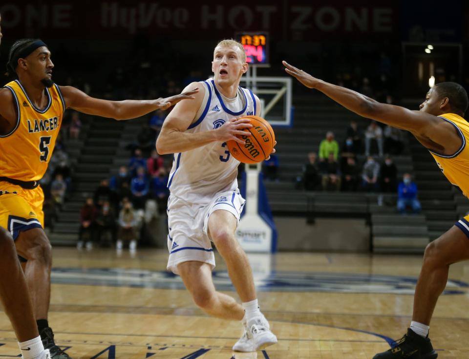 Drake guard Garrett Sturtz drives to the basket between two Mount Mary defenders in the first half of an NCAA men's basketball game on Tuesday, Dec. 28, 2021, at the Knapp Center at Drake University in Des Moines, Iowa.