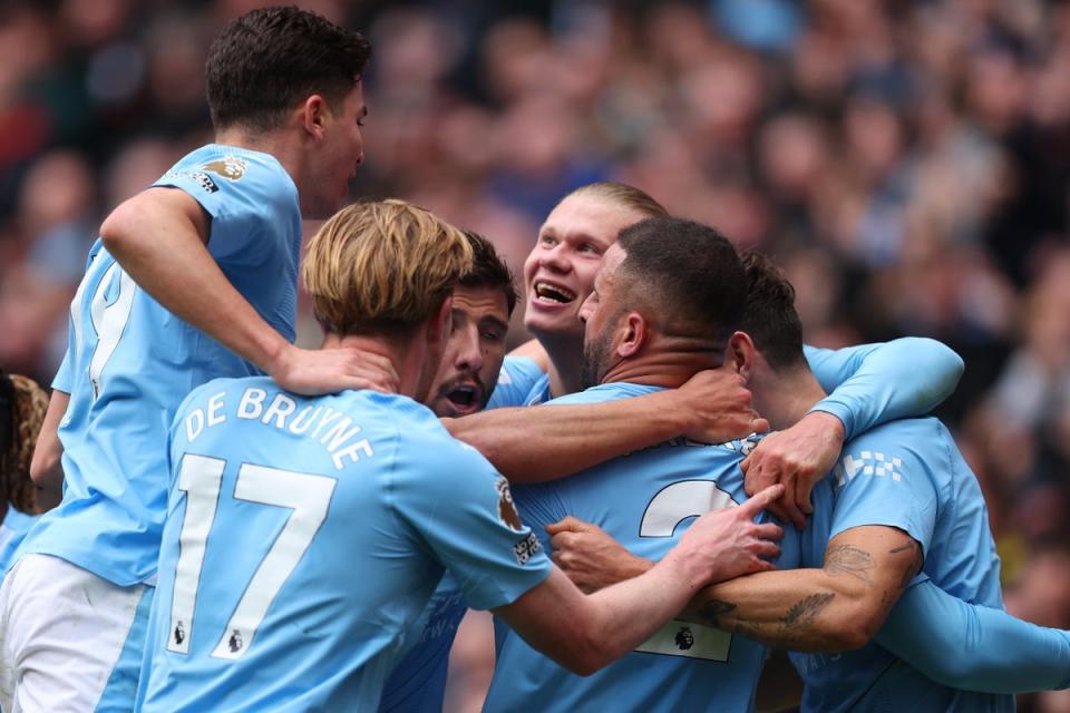 Erling Haaland is swamped by his teammates after scoring  (EPA)