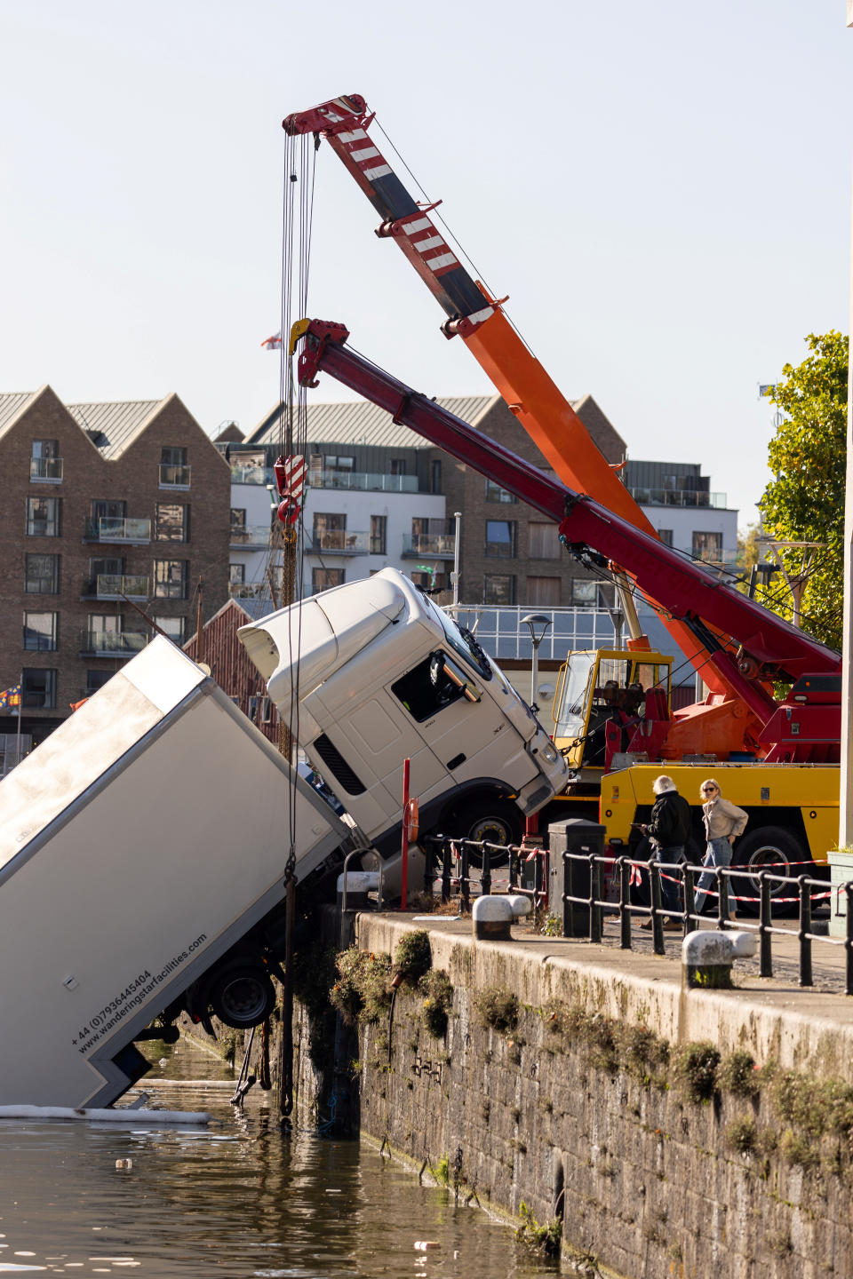 Several cranes were required to pull the lorry out of the water. (SWNS)