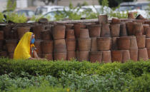 A woman waits for her COVID-19 test at a hospital in New Delhi, India, Monday, July 6, 2020. India has overtaken Russia to become the third worst-affected nation by the coronavirus pandemic. (AP Photo/Manish Swarup)