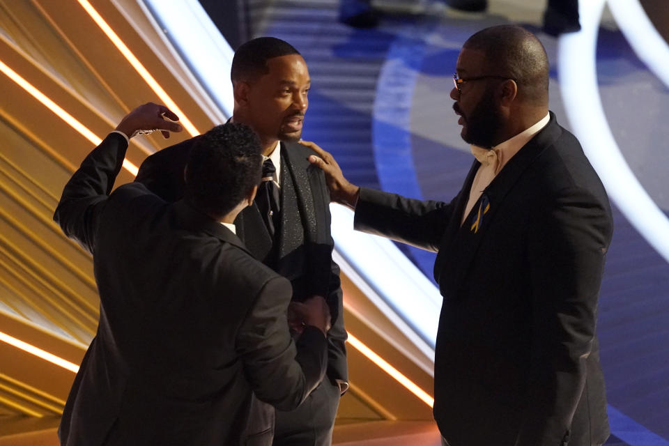 Sean Combs, from left, Will Smith and Tyler Perry appear in the audience at the Oscars on Sunday, March 27, 2022, at the Dolby Theatre in Los Angeles. (AP Photo/Chris Pizzello)