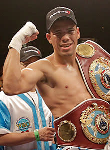 Juan Manuel Lopez shows off his hardware after defeating Rafael Marquez by TKO