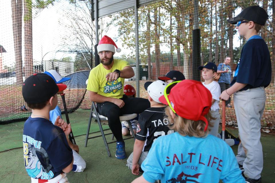 Savannah Bananas catcher Bill LeRoy has a nickname for each camper as he gets them ready for batting practice on Tuesday at Grayson Stadium. 