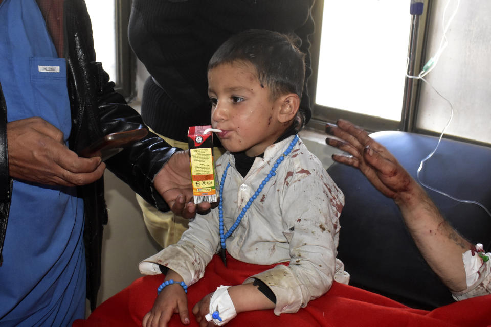 A boy injured in a suicide bombing, drinks juice after receiving treatment at a hospital in Quetta, Pakistan, Wednesday, Nov. 30, 2022. A suicide bomber blew himself up near a truck carrying police officers on their way to protect polio workers outside Quetta officials said. (AP Photo/Arshad Butt)