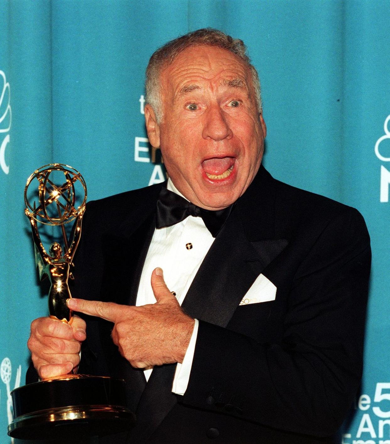 Comedian Mel Brooks points to his Emmy awardat the