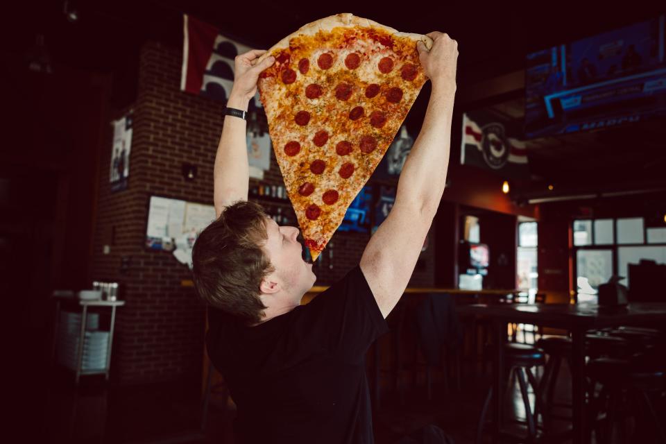 The Mega Slice is 26 inches long, that’s over two feet of Dough Co. Pizza’s hand tossed dough, house sauce and shredded mozzarella.