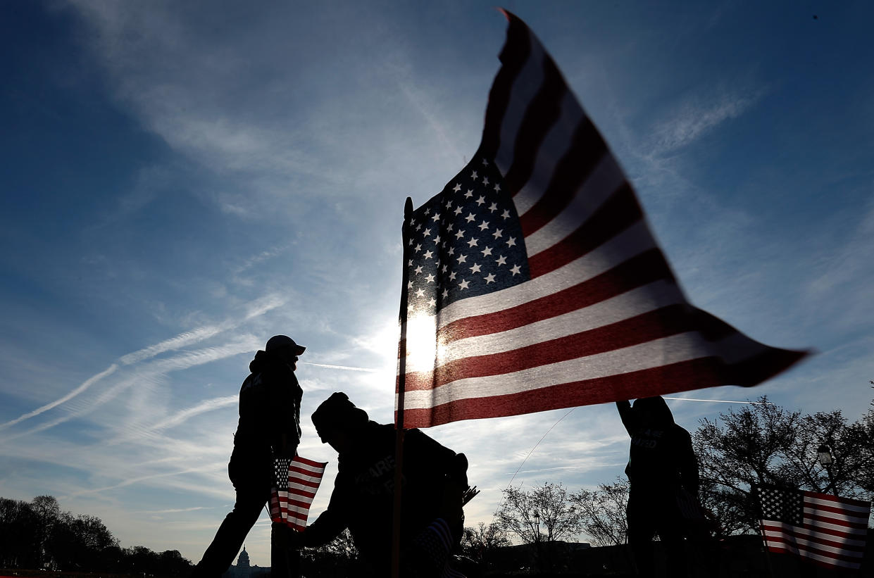 Veterans with American flag. (Getty Images)