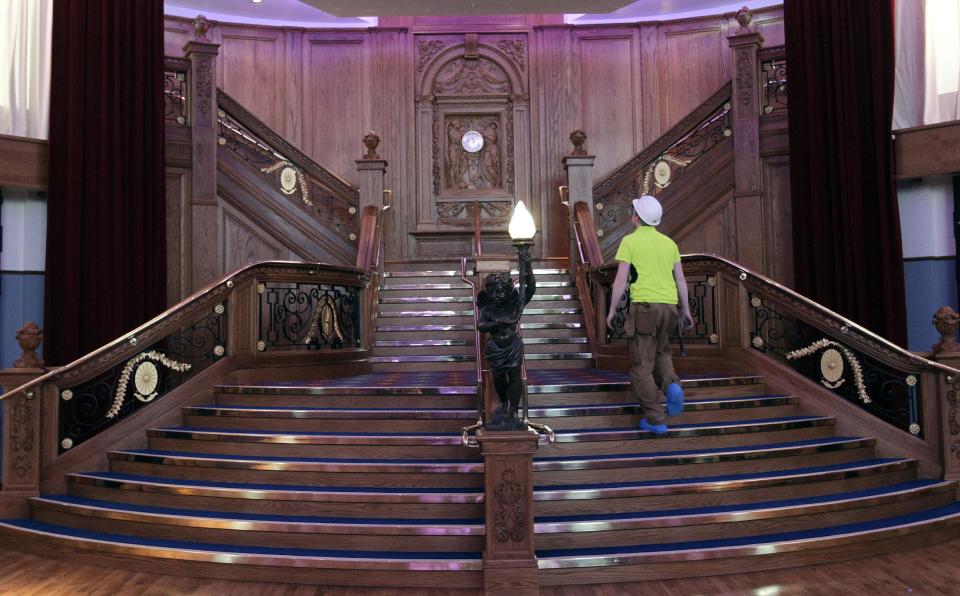 In this photo of Tuesday March 13, 2012 a replica of the the famous staircase onboard the Titanic Ship is on display in the new 100 million British pounds ($157 million)Titanic Belfast Visitor's Center, in Belfast, Northern Ireland. Celebrating the ship and the people who built her is the aim of Titanic Belfast, a shiny new "visitor experience" _ don't call it a museum _ whose four prow-like wings jut jauntily skyward beside the River Lagan on the site of the old Harland and Wolff shipyard. Titanic, the world's largest, most luxurious ocean liner, left this spot on April 2, 1912 on its maiden voyage from England to New York. Twelve days later, it stuck an iceberg off the coast of Newfoundland and sank in the early hours of April 15. More than 1,500 of the 2,200 people on board died. (AP Photo/Peter Morrison)