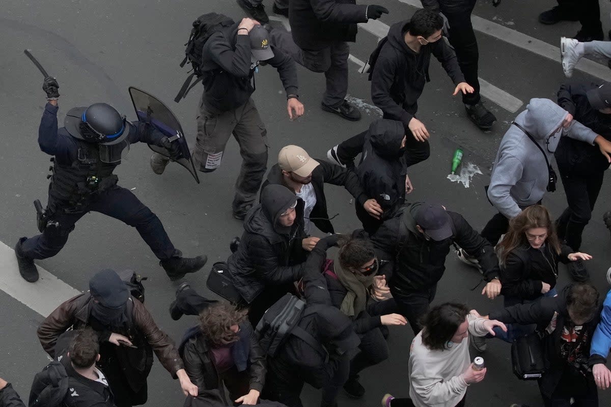 Riot police scuffle with protesters during a rally in Paris on Thursday (AP)