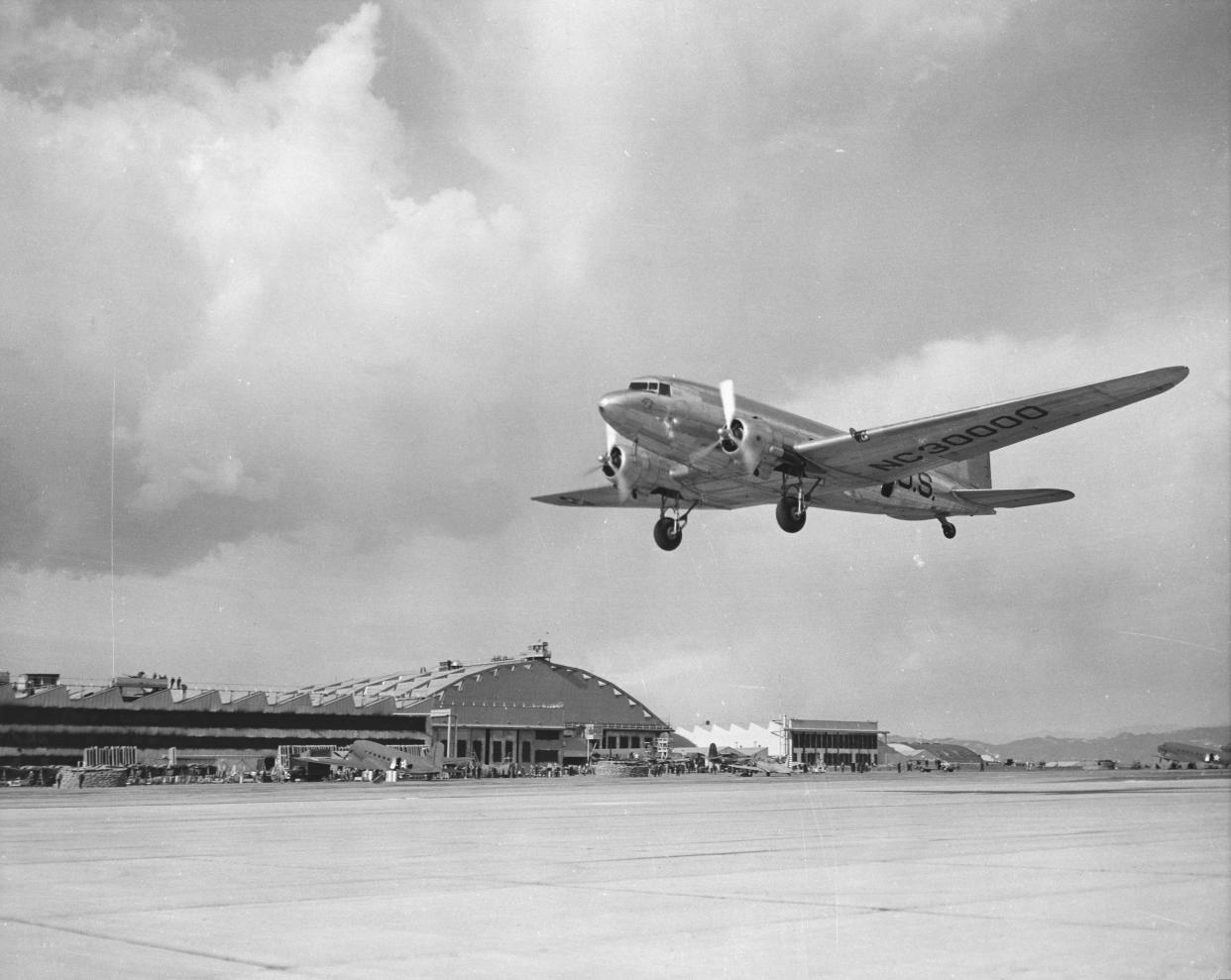 A low angle view of a Douglas DC-3 landing, similar to one that vanished over the Bermuda Triangle in 1948.