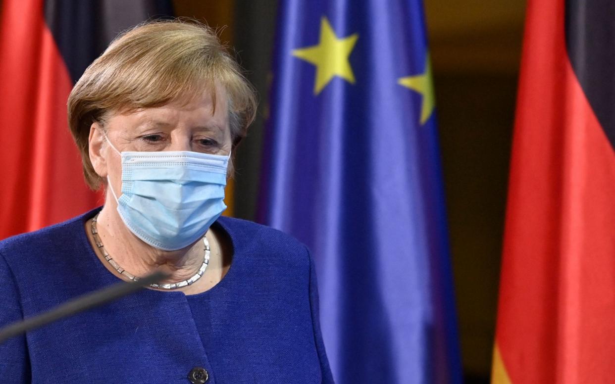 German Chancellor Angela Merkel arrives for a press conference following the EU leaders' videoconference in Berlin on February 25, 2021. (Photo by John MACDOUGALL / various sources / AFP) (Photo by JOHN MACDOUGALL/AFP via Getty Images) - JOHN MACDOUGALL/AFP