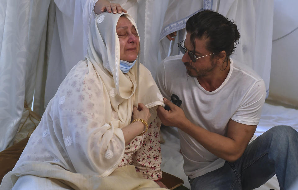 Actor Shahrukh Khan, right, consoles Saira Banu as she mourns death of her husband and Bollywood icon Dilip Kumar at their residence in Mumbai, India, Wednesday, July 7, 2021. Dilip Kumar, hailed as the "Tragedy King" and one of Hindi cinema's greatest actors, died Wednesday in a Mumbai hospital after a prolonged illness. He was 98. (Kunal Patil/Pool photo via AP)