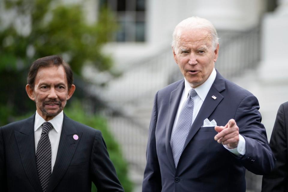 Sultan of Brunei Haji Hassanal Bolkiah looks on as US president Joe Biden reacts to a reporter’s question during a family photo for the US-ASEAN Special Summit on the South Lawn of the White House on 12 May 2022 in Washington, DC (Getty Images)