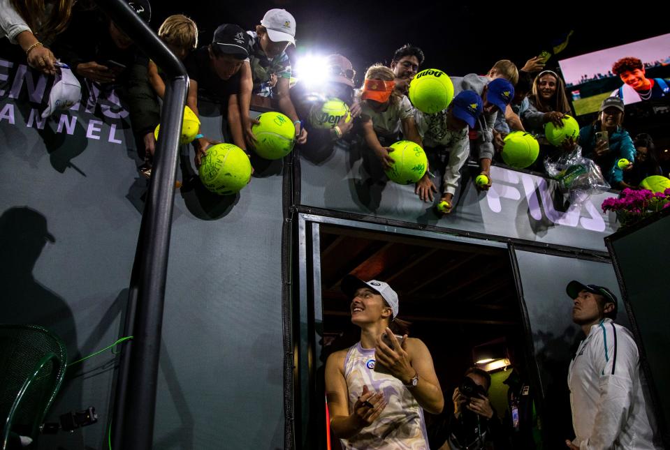 Iga Swiatek walks back out of the tunnel to sign autographs for fans after winning her match over Bianca Andreescu at the BNP Paribas Open at the Indian Wells Tennis Garden in Indian Wells, Calif., Monday, March 13, 2023. 