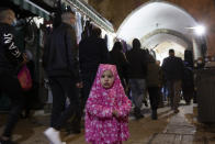 A Palestinian toddler wears a jilbab, an Islamic garment, on the eve of the Muslim holy month of Ramadan in the Old City of Jerusalem, Monday, April 12, 2021. (AP Photo/Maya Alleruzzo)
