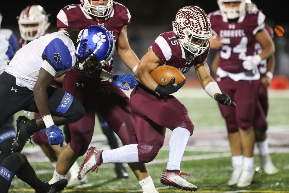 Caravel senior Jordan Miller breaks through the line for a big gain against Howard in the Class 2A semifinals. Miller was named the Class 2A Offensive Player of the Year by the Delaware Interscholastic Football Coaches Association on Monday.
