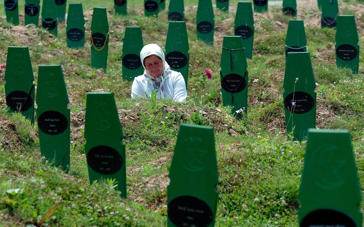 A woman visits the grave of her brother, who was killed in Srebrenica in 1995 by Serb forces - EPA