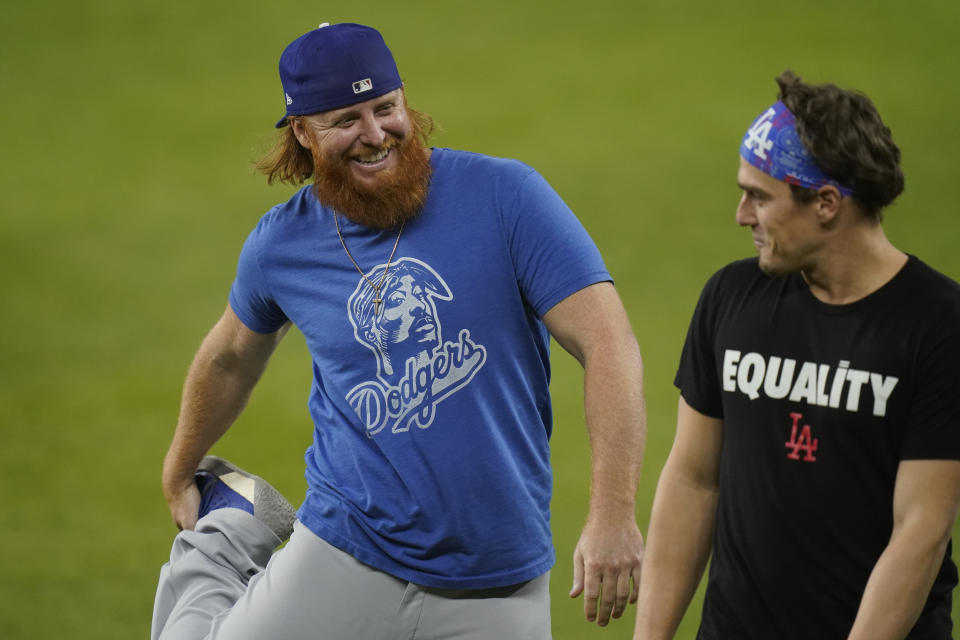 Los Angeles Dodgers third baseman Justin Turner, left, and second baseman Enrique Hernandez warm up during batting practice before Game 5 of the baseball World Series against the Tampa Bay Rays Sunday, Oct. 25, 2020, in Arlington, Texas. (AP Photo/Eric Gay)