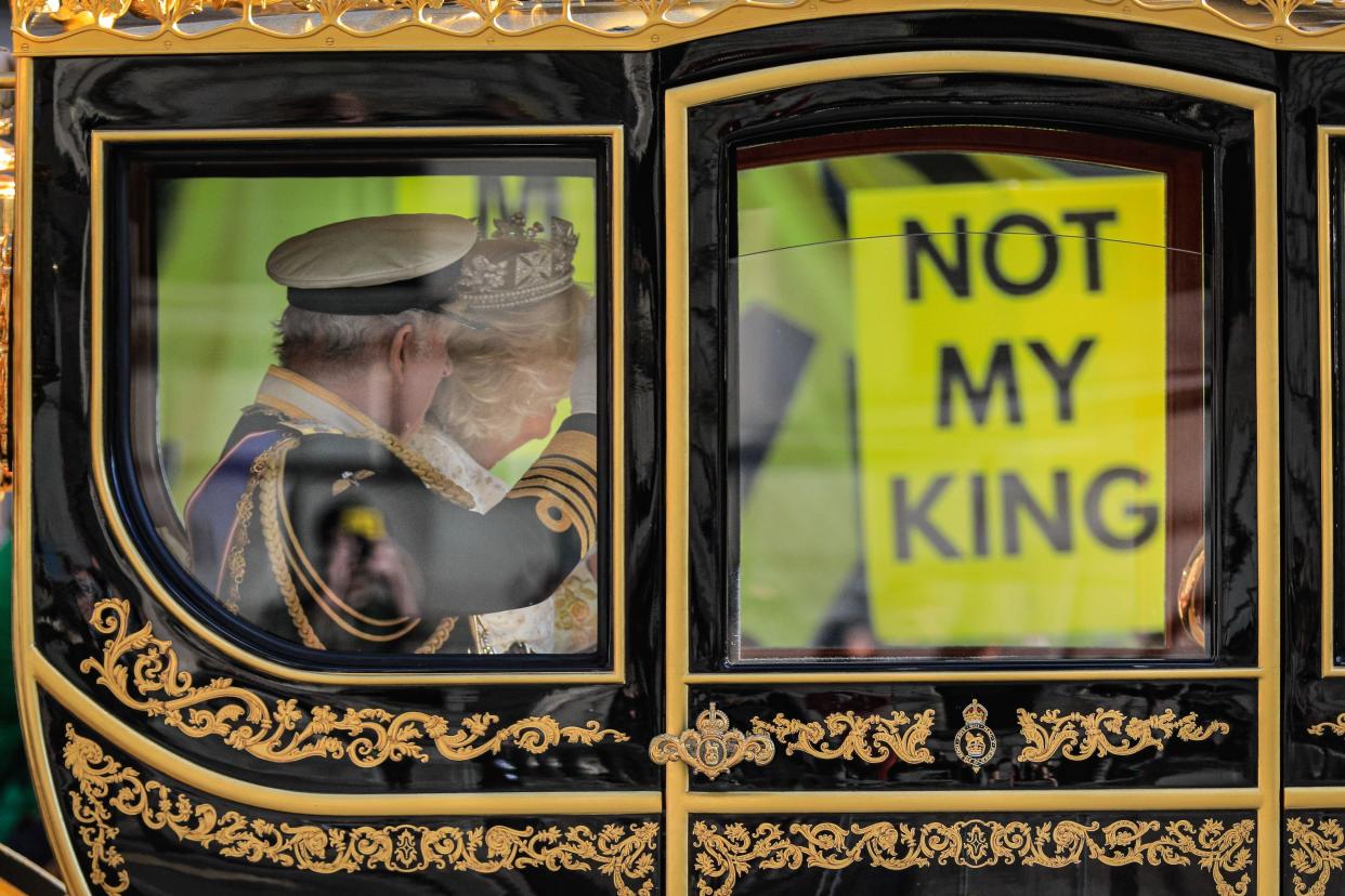 London, UK. 07th Nov, 2023. HRH King Charles III and Queen Camilla in the carriage. They appear to look and wave at anti-royalist protesters holding 