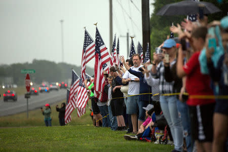 A crowd of spectators watch as the funeral procession for former first lady Barbara Bush passes through Hempstead, Texas, U.S., April 21, 2018. REUTERS/Tamir Kalifa