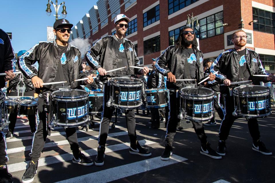 From left, Detroit Lions drumline members Rico Ortiz, Jack Tallman, John Williams and Mackenzie Fox Purrier perform for fans waiting at Gate A of Ford Field before the game against Chicago Bears on Sunday.