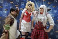 "Prussia" (Sami Whitesides), left, "HarleyQuinn" (Jade Lindgren), and "Zuko" (Mattie Csicsery) pose for a photo at the opening day of Salt Lake Comic Con, Thursday, April 17, 2014, in Salt Lake City, Utah. (AP Photo/The Salt Lake Tribune, Scott Sommerdorf)